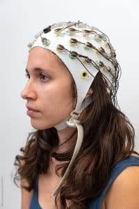 Woman wearing an EEG cap.